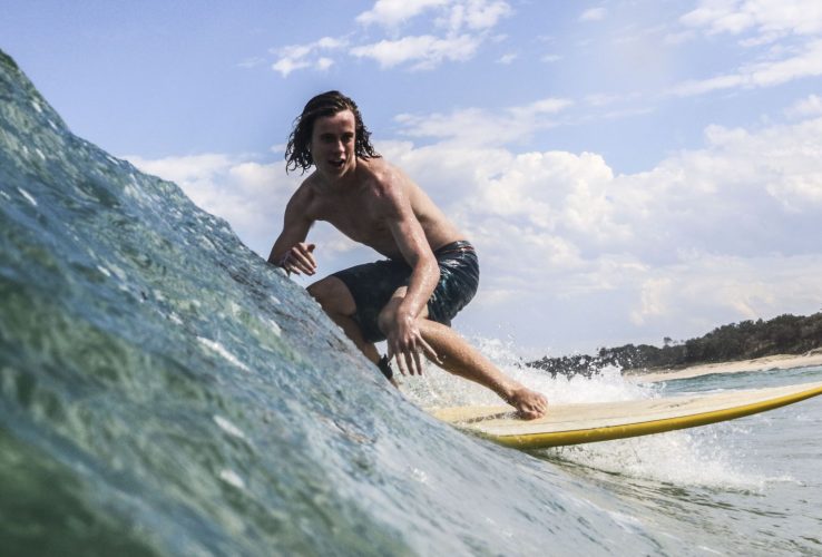 Surfer catching a great wave at Coffs Harbour best beach near Diggers Beach Accommodation