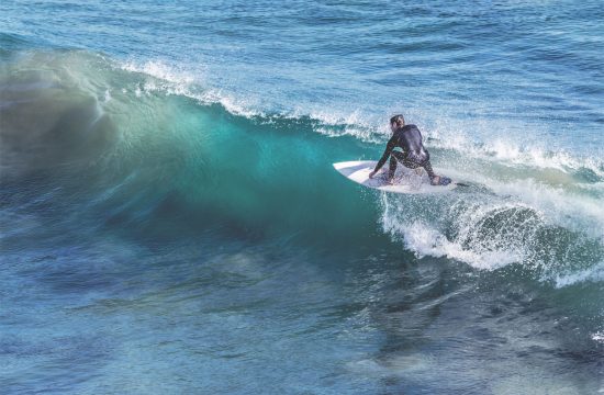 Person surfing a wave at diggers beach