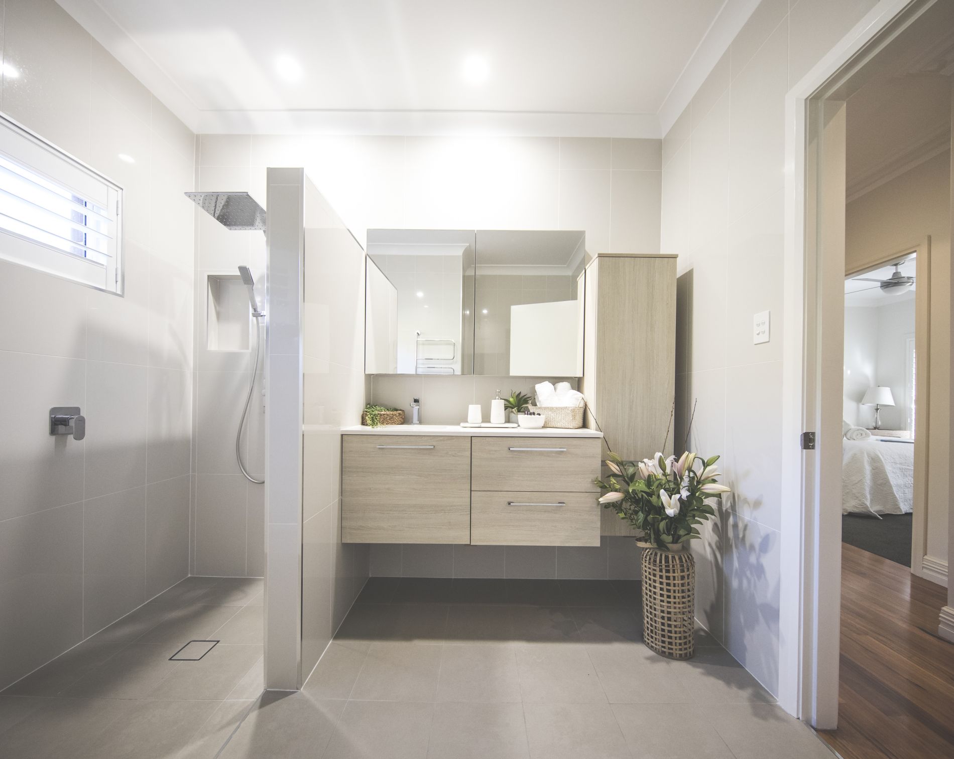 Modern sleek bathroom with shower and sink at diggers beach cottage